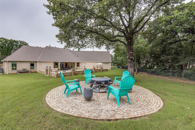 exterior space with a patio area, fence, and a fire pit