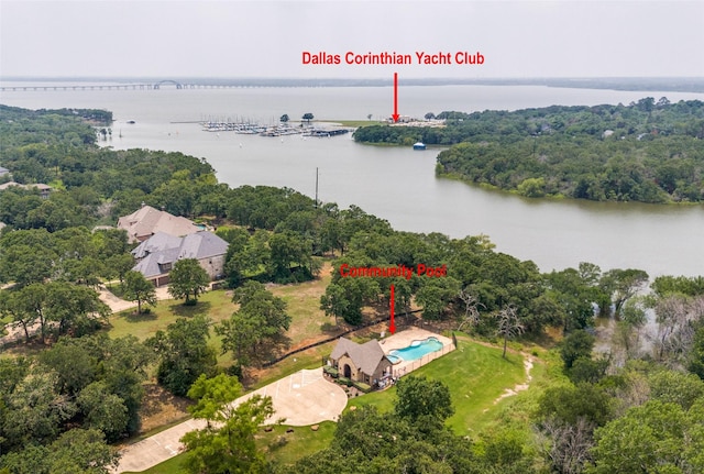 birds eye view of property with a forest view and a water view