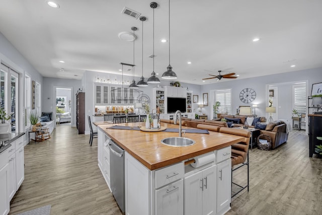 19909 County Road 1102, Flint, TX 75762 - kitchen with butcher block counters, a sink, a ceiling fan, recessed lighting, and white cabinets