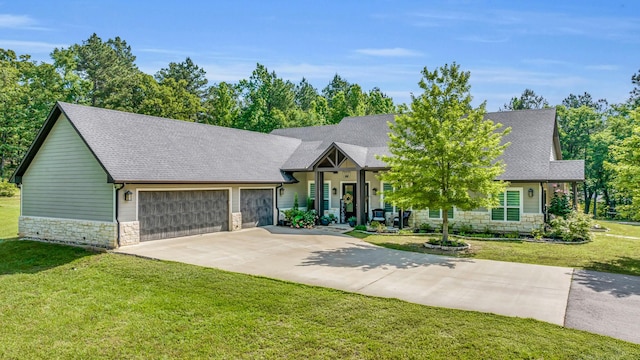 19909 County Road 1102, Flint, TX 75762 - view of front of home with stone siding, driveway, a garage, a front yard, and a shingled roof