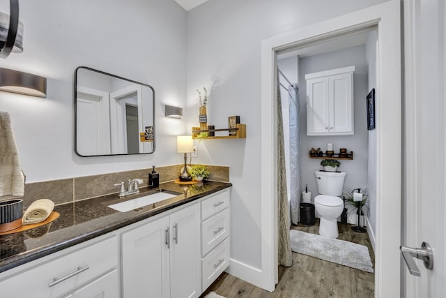 19909 County Road 1102, Flint, TX 75762 - full bathroom with toilet, wood finished floors, vanity, and baseboards