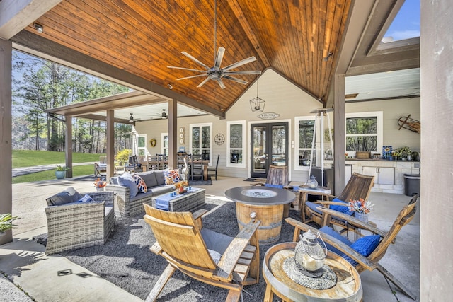 19909 County Road 1102, Flint, TX 75762 - view of patio with ceiling fan, an outdoor living space with a fire pit, and french doors