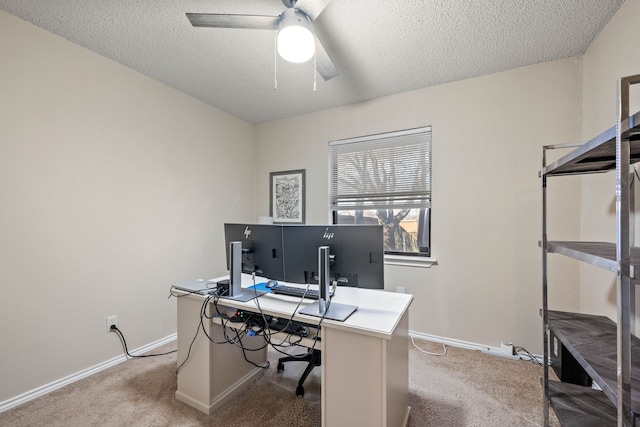 carpeted home office featuring ceiling fan, baseboards, and a textured ceiling