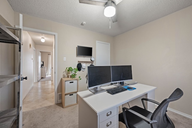 office space with light carpet, baseboards, a textured ceiling, and ceiling fan