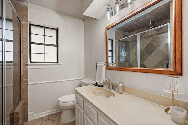 bathroom with vanity, tile patterned flooring, a shower stall, crown molding, and toilet