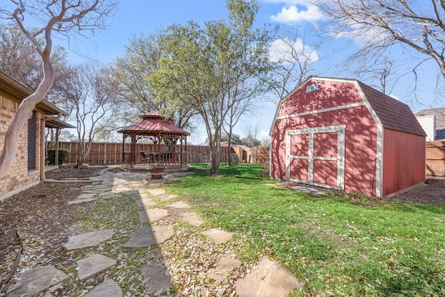 view of yard with a gazebo, a shed, an outbuilding, and a fenced backyard