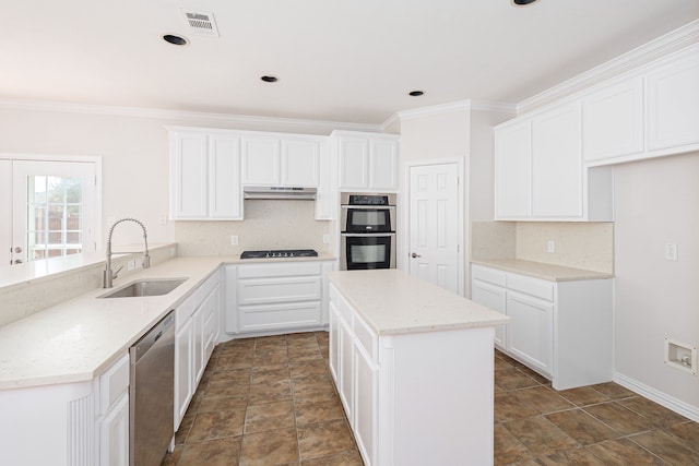 kitchen with appliances with stainless steel finishes, decorative backsplash, a sink, and under cabinet range hood