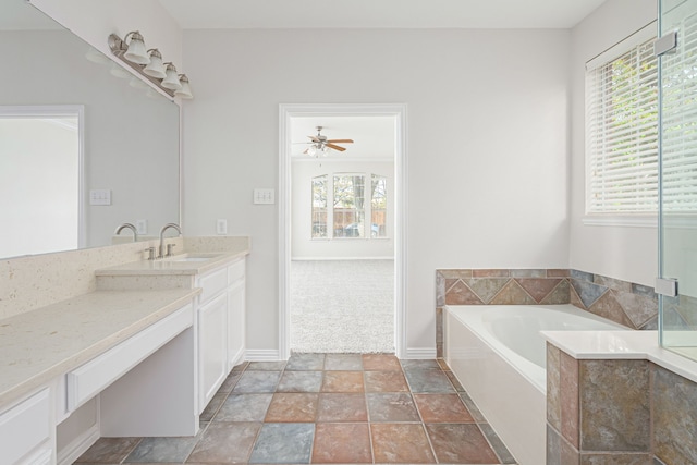 full bath featuring a ceiling fan, vanity, a bath, and baseboards