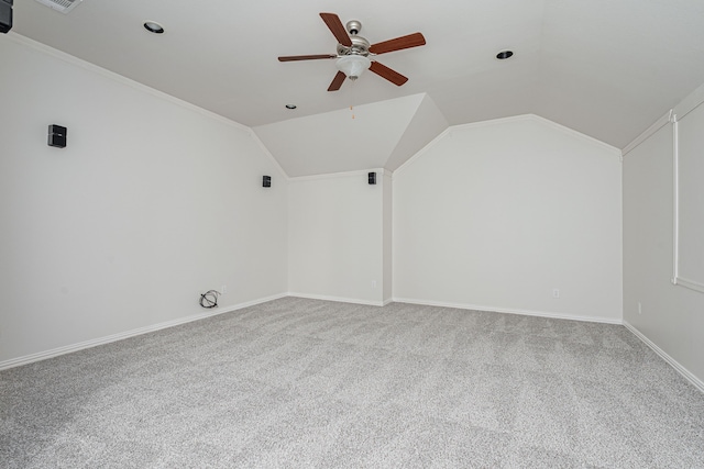 additional living space featuring vaulted ceiling, carpet floors, a ceiling fan, and baseboards