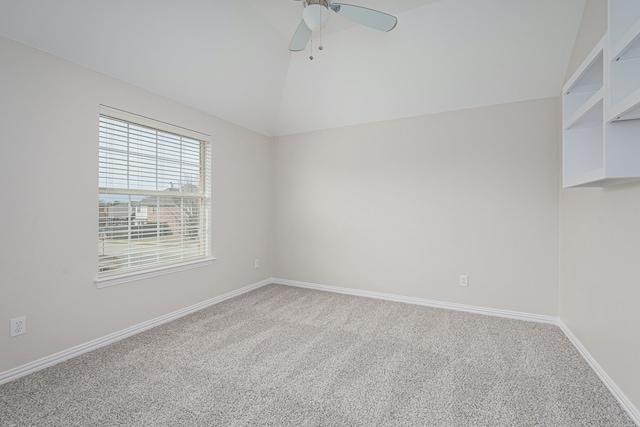 unfurnished room with ceiling fan, baseboards, vaulted ceiling, and carpet flooring