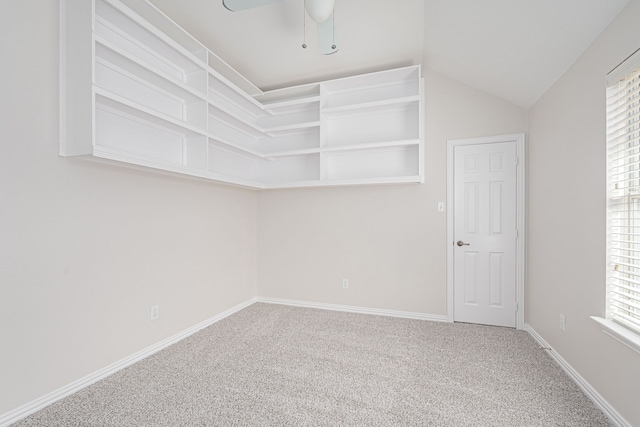 walk in closet featuring a ceiling fan, carpet, and vaulted ceiling