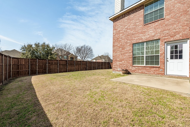 view of yard featuring a patio area and a fenced backyard