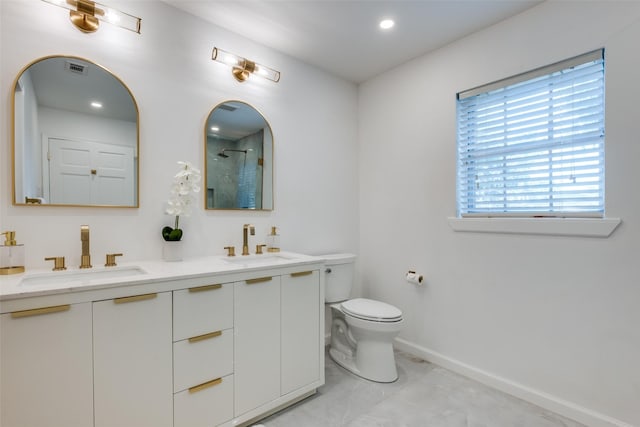 bathroom with a shower, a sink, toilet, and baseboards