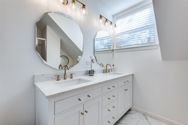 bathroom with double vanity, marble finish floor, baseboards, and a sink