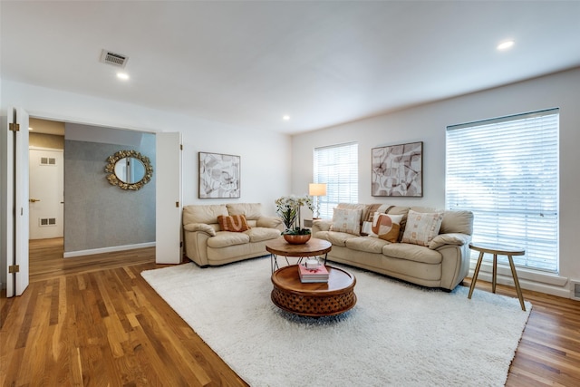 living area featuring visible vents, wood finished floors, and recessed lighting