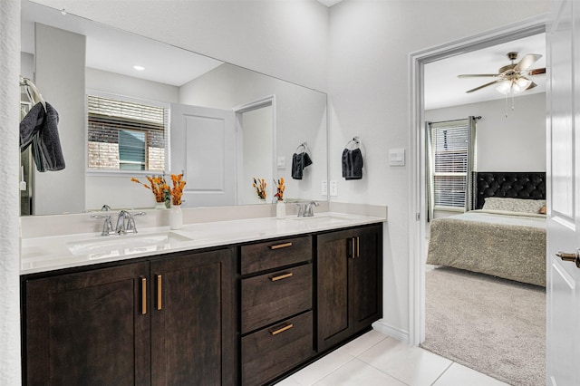 ensuite bathroom featuring a sink, ceiling fan, ensuite bathroom, and tile patterned flooring