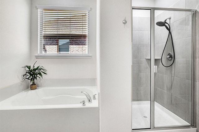 full bathroom featuring a bath and a stall shower