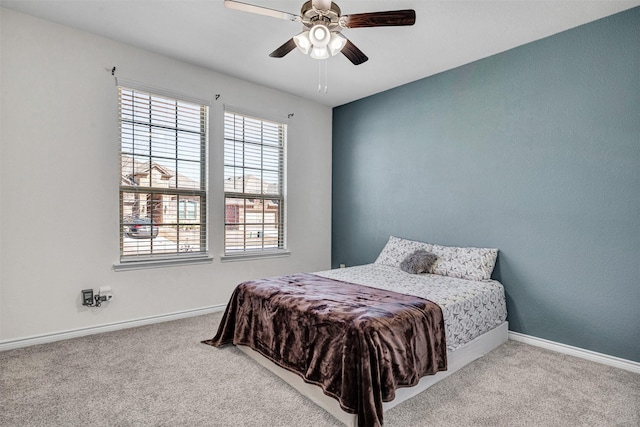 carpeted bedroom with baseboards and ceiling fan