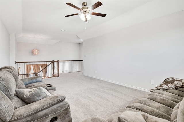 living room featuring carpet flooring, visible vents, a ceiling fan, and baseboards