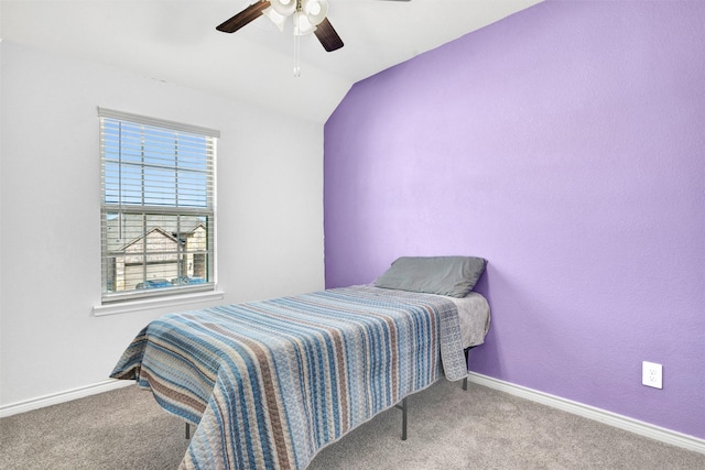 carpeted bedroom with baseboards, a ceiling fan, and vaulted ceiling