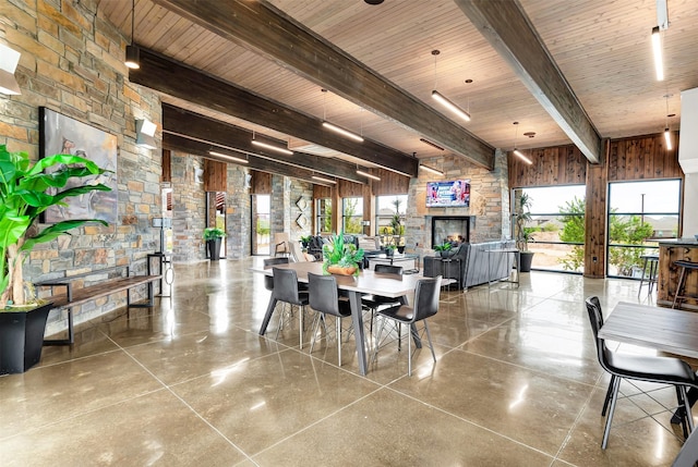 10508 Bluestone Ln, Aubrey, TX 76227 - dining space with a fireplace, wood ceiling with exposed beams, french doors, and wooden walls