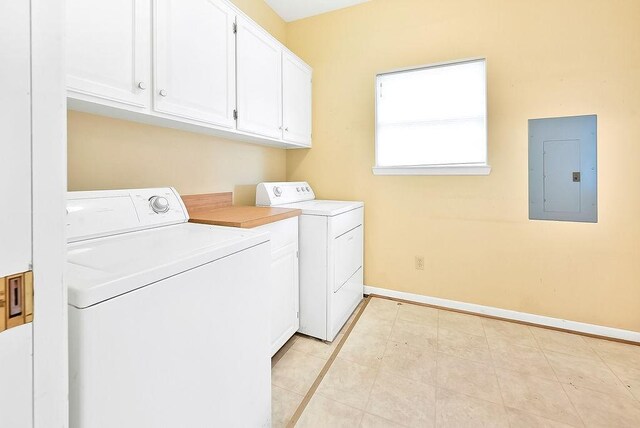 washroom with independent washer and dryer, cabinet space, electric panel, and baseboards