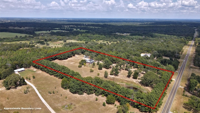 drone / aerial view featuring a rural view and a wooded view