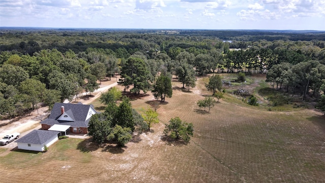 drone / aerial view featuring a wooded view