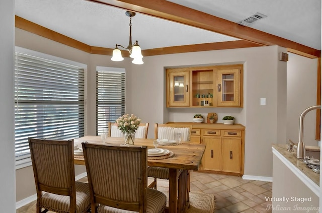 6090 Dorchester Cir, Keithville, LA 71047 - dining room with visible vents, baseboards, beam ceiling, an inviting chandelier, and stone tile floors
