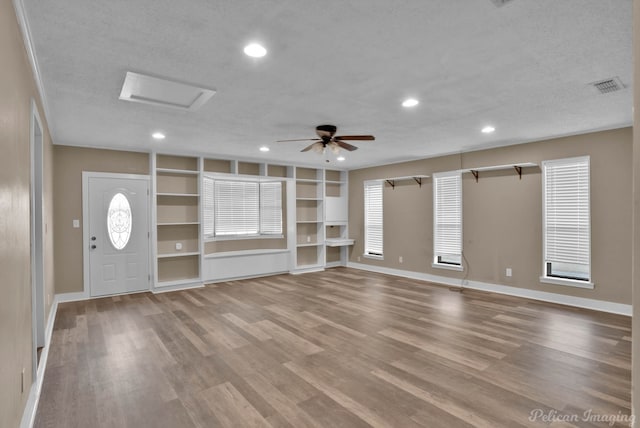 6090 Dorchester Cir, Keithville, LA 71047 - unfurnished living room featuring attic access, a ceiling fan, wood finished floors, and a textured ceiling