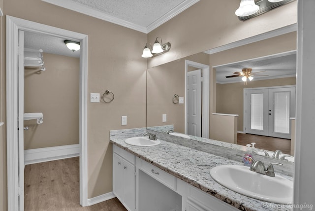 6090 Dorchester Cir, Keithville, LA 71047 - full bathroom with a textured ceiling, a sink, ornamental molding, and wood finished floors