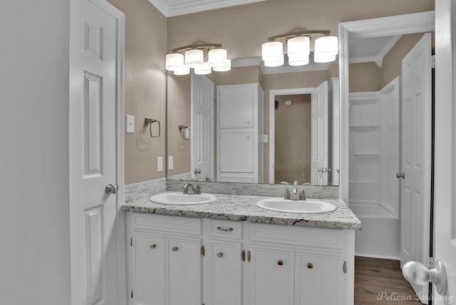 6090 Dorchester Cir, Keithville, LA 71047 - bathroom with double vanity, a sink, ornamental molding, and wood finished floors