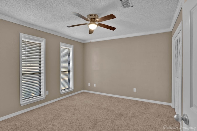 6090 Dorchester Cir, Keithville, LA 71047 - unfurnished bedroom with a closet, crown molding, carpet flooring, a textured ceiling, and visible vents