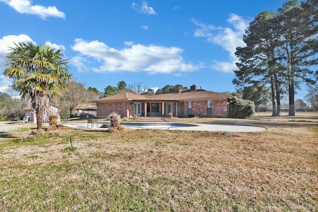 6090 Dorchester Cir, Keithville, LA 71047 - back of house featuring a lawn, a chimney, fence, and brick siding