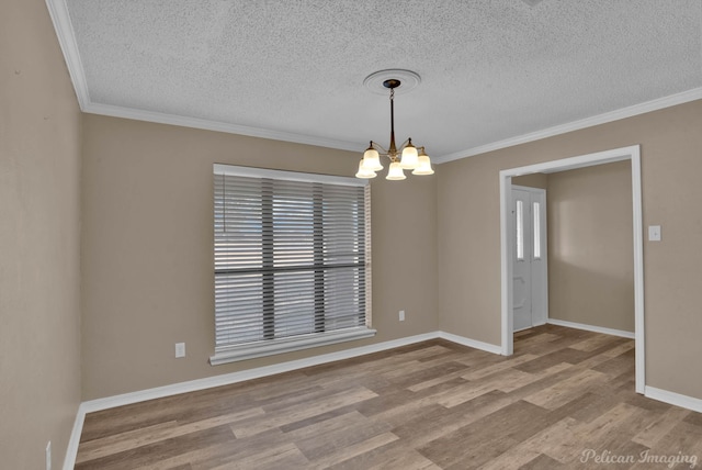 6090 Dorchester Cir, Keithville, LA 71047 - spare room with wood finished floors, an inviting chandelier, and crown molding
