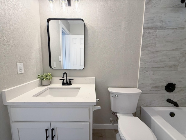 full bathroom featuring baseboards, a textured wall, toilet, vanity, and shower / bathing tub combination