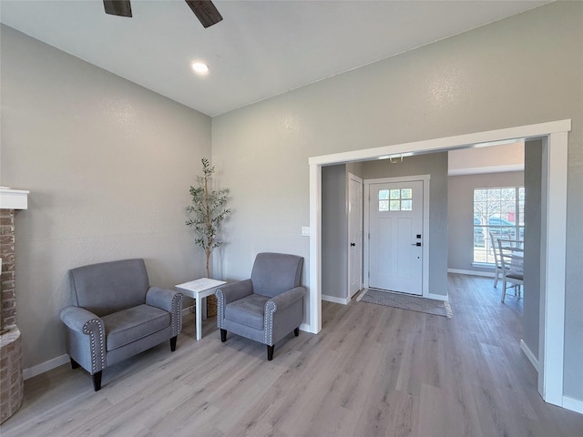 entryway with light wood-type flooring, baseboards, and a ceiling fan