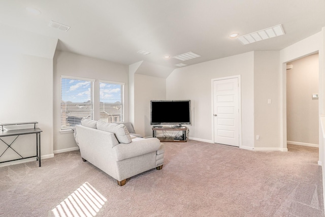 living room with light carpet, visible vents, baseboards, and lofted ceiling