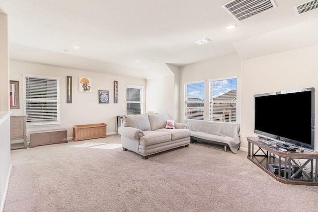 living area featuring recessed lighting, visible vents, and carpet flooring