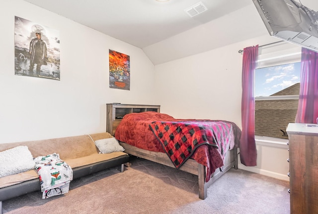 carpeted bedroom featuring lofted ceiling, baseboards, and visible vents