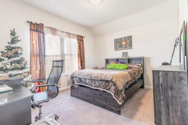 bedroom featuring carpet floors, lofted ceiling, and baseboards