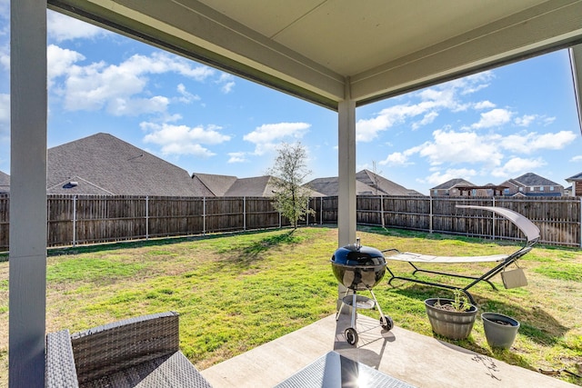 view of yard with a residential view, a patio area, and a fenced backyard