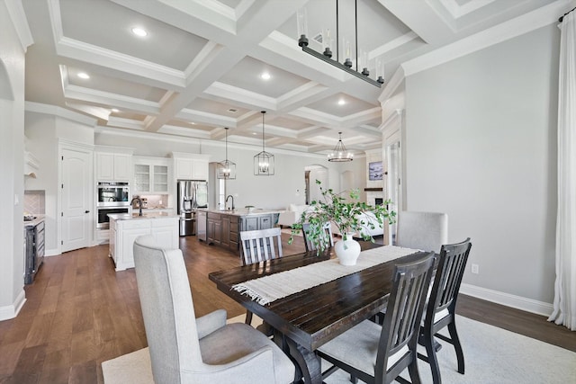 dining area with dark wood-style floors, coffered ceiling, beam ceiling, and recessed lighting