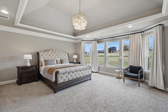 bedroom with a raised ceiling, visible vents, baseboards, and an inviting chandelier