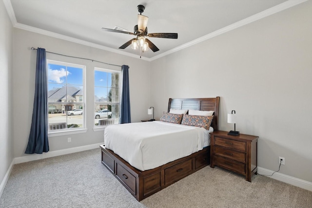 bedroom with ornamental molding, light colored carpet, ceiling fan, and baseboards