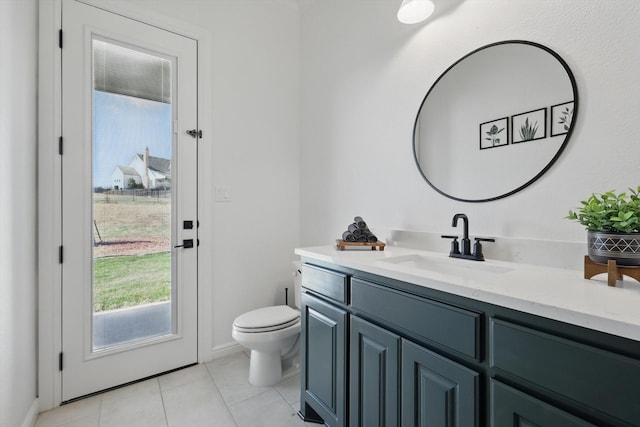 bathroom featuring tile patterned flooring, vanity, and toilet