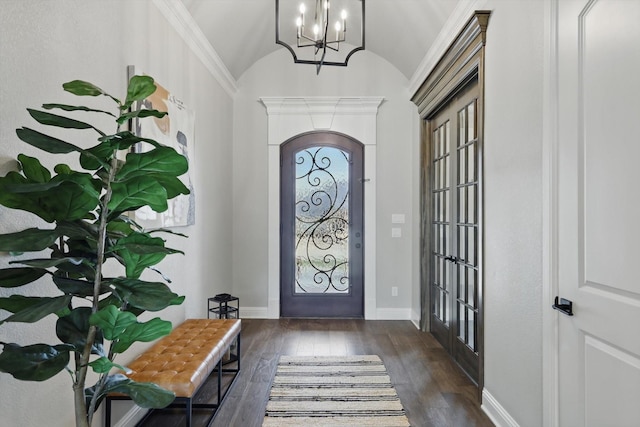 entryway featuring wood-type flooring, baseboards, vaulted ceiling, and a notable chandelier