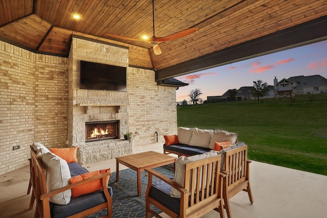 view of patio featuring an outdoor living space with a fireplace