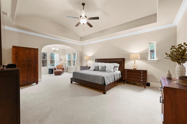 carpeted bedroom with arched walkways, baseboards, vaulted ceiling, ornamental molding, and a raised ceiling