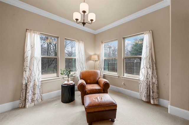 living area with carpet floors, a chandelier, ornamental molding, and baseboards